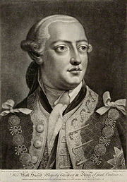 Head-and-shoulders monochrome portrait of a young clean-shaven man wearing a richly-patterned jacket, plain neckcloth, powdered wig, and the chain of office or livery collar of the Order of the Garter.