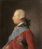 Quarter-length portrait in oils of a clean-shaven young man in profile wearing a red suit, the Garter star, a blue sash, and a powdered wig. He has a receding chin and his forehead slopes away from the bridge of his nose making his head look round in shape.